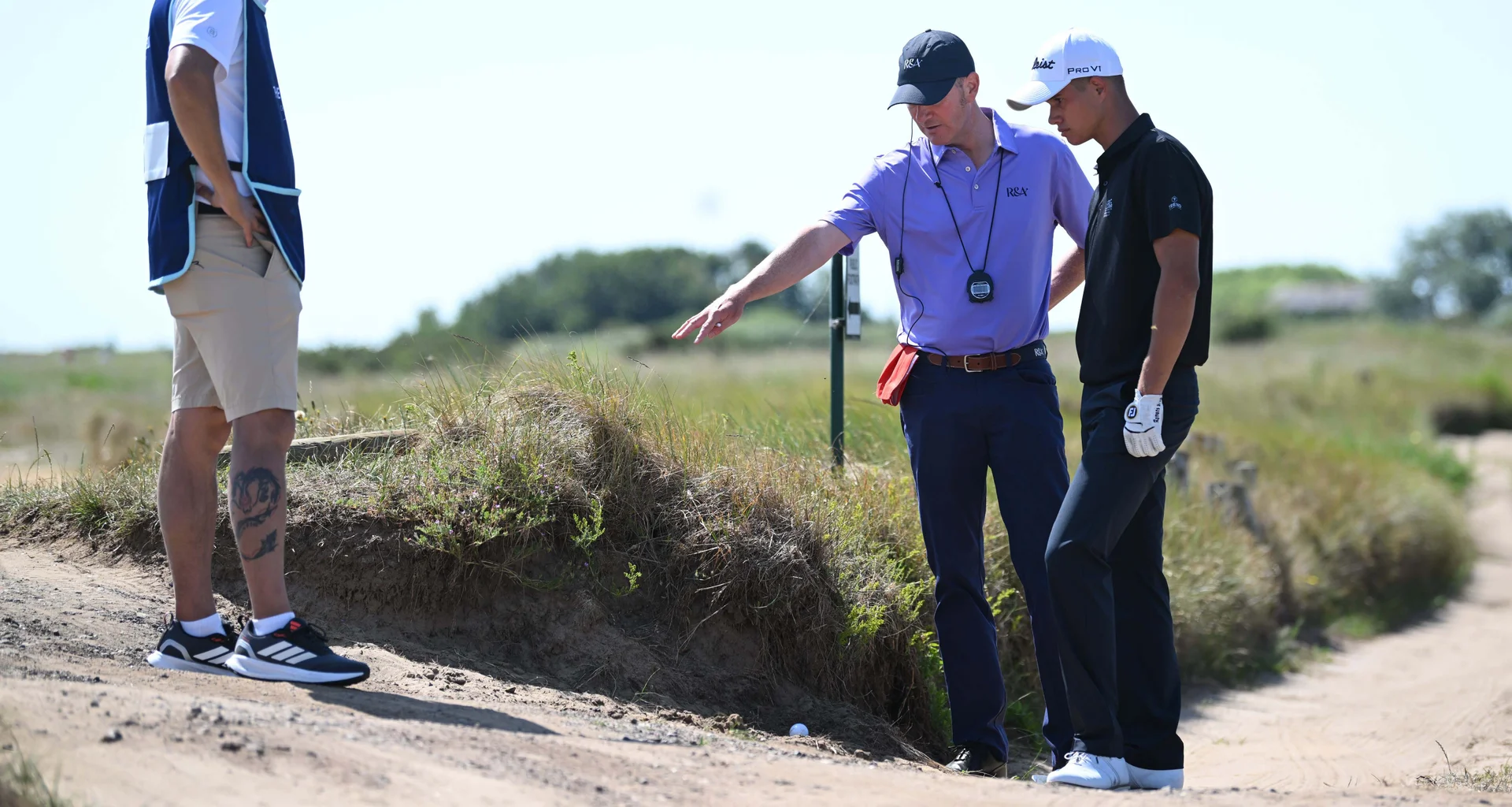 Andreas Roman of Romania gets a ruling during Day Two of The Amateur Championship at Royal Cinque Ports Golf Club on June 17, 2025 in Deal, England.